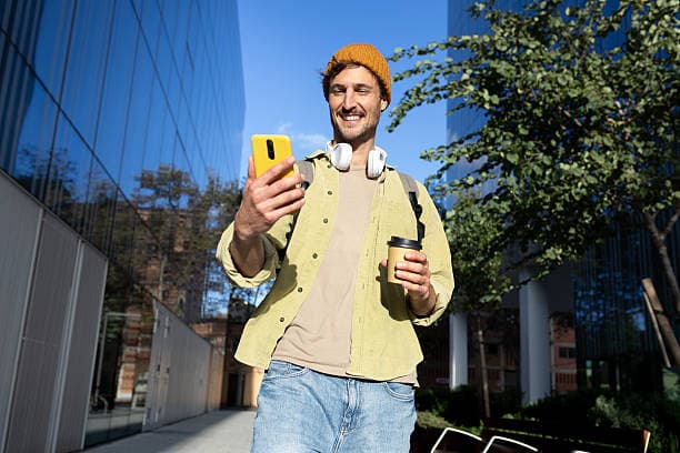 Traveller checking his phone outdoors