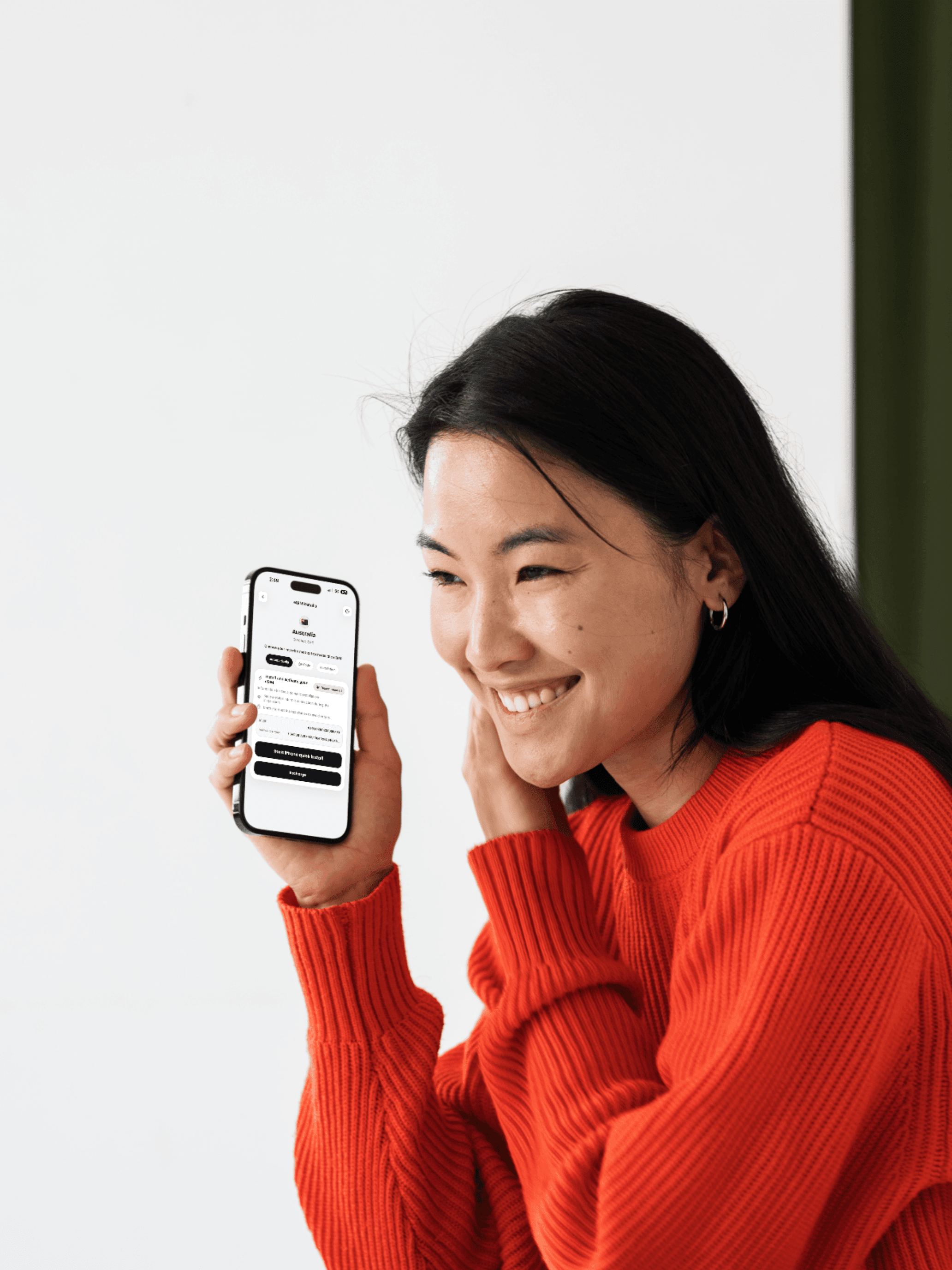 A creator holding a phone with the Ozly app open