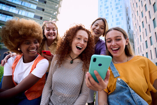 Friends gathered around a phone while travelling