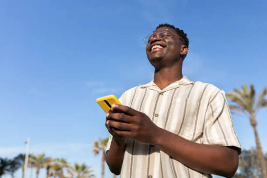 Traveller checking his phone on a sunny trip